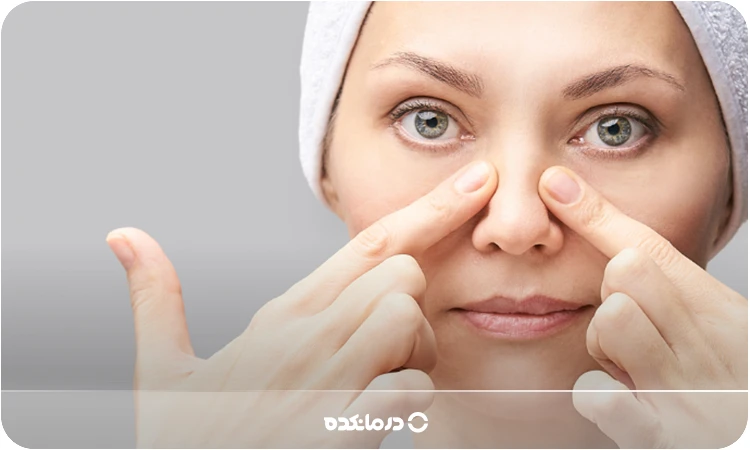 تصویر یک شخص در حال ماساژ دادن بینی خودش را می بینید